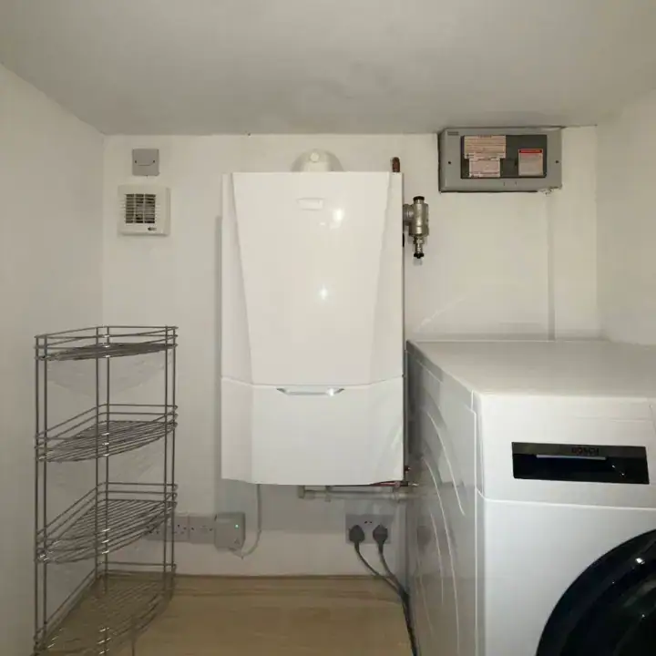 Gas boiler and washing machine in utility room, Leeds, Yorkshire, UK.